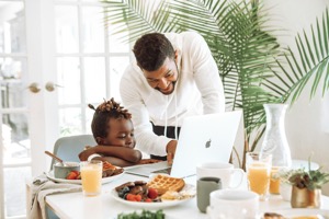 A Black woman reading with a child